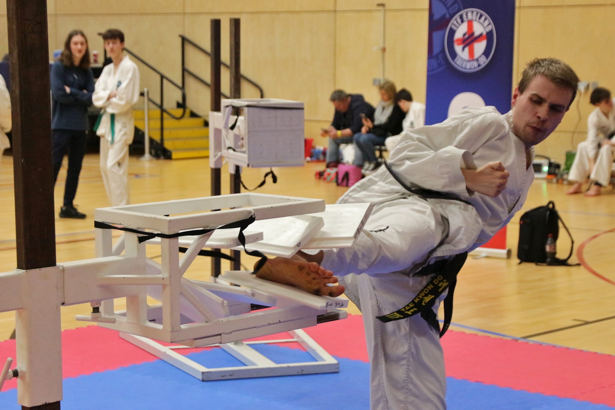 Daniel Beard breaking 3 stacked boards simultaneously with a side kick.